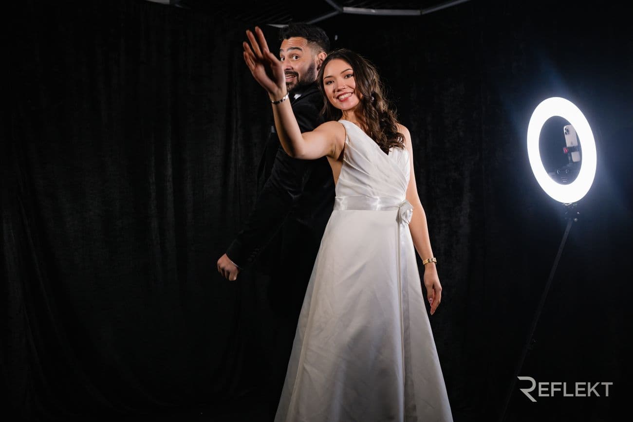 Bride waving in front of a ring-light video booth