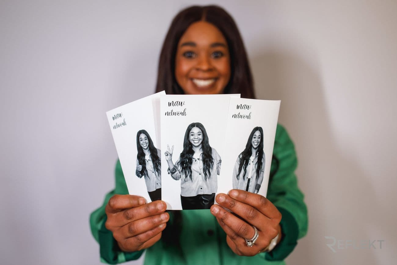 Guest holding black-and-white glam booth portrait prints