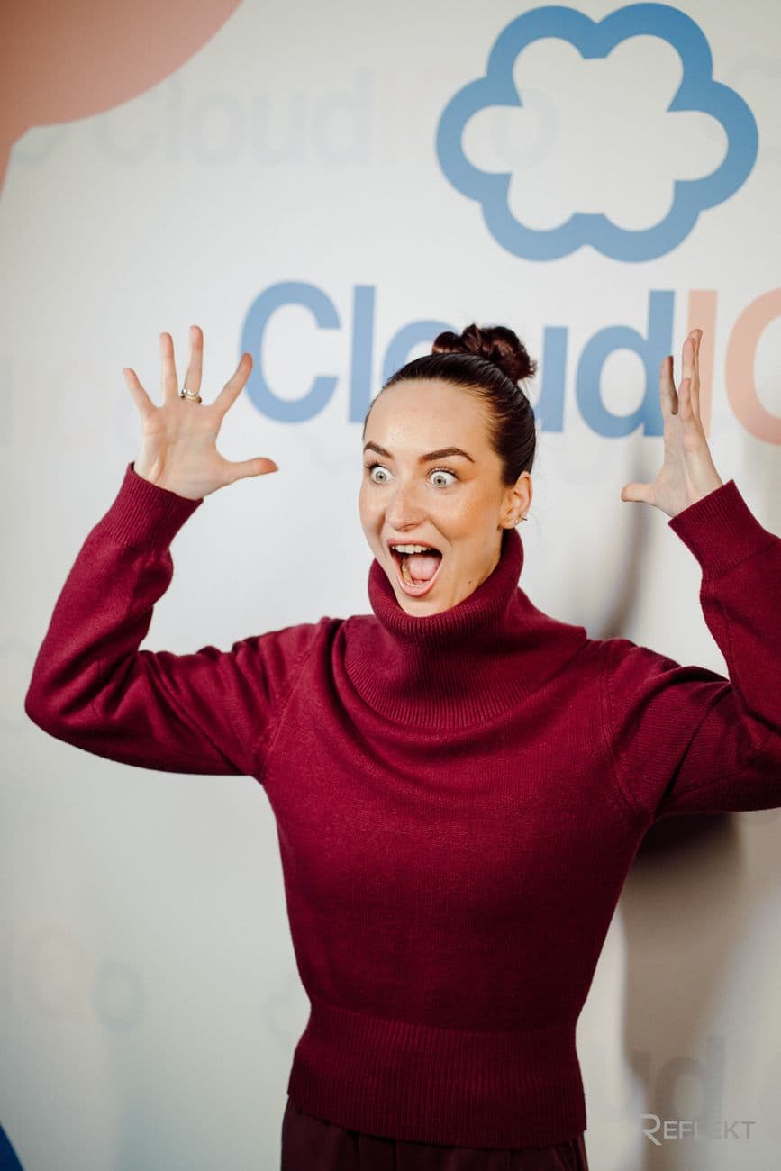 Guest reacting in front of a branded photo booth backdrop