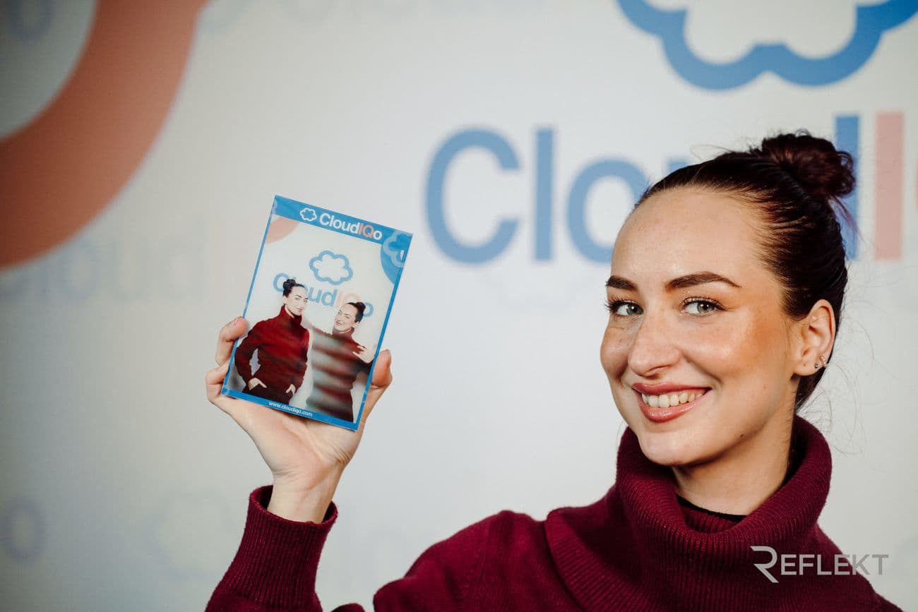 Guest holding a branded lenticular photo card from a corporate photo booth
