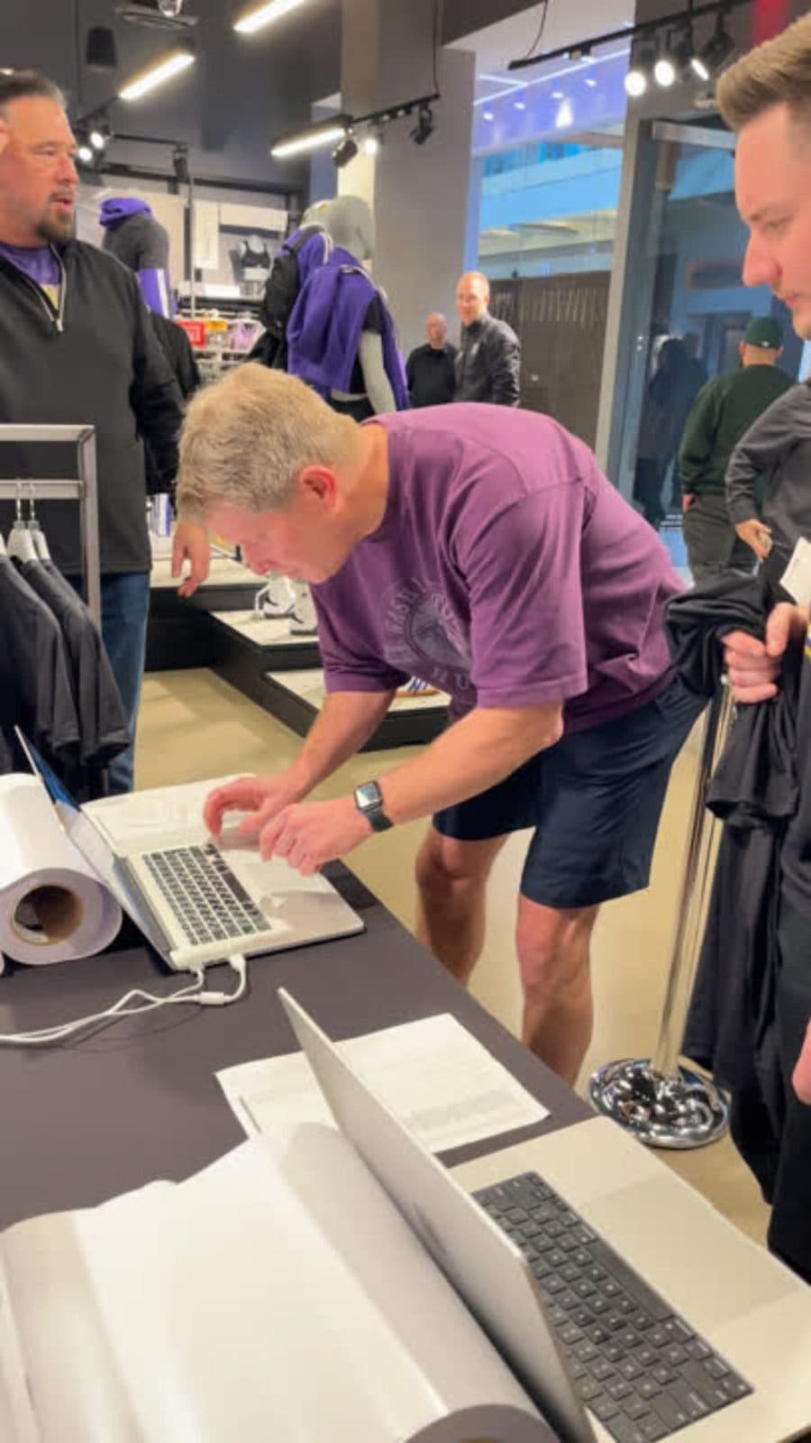 Staff member setting up a guest's custom design on a laptop at a live personalization station