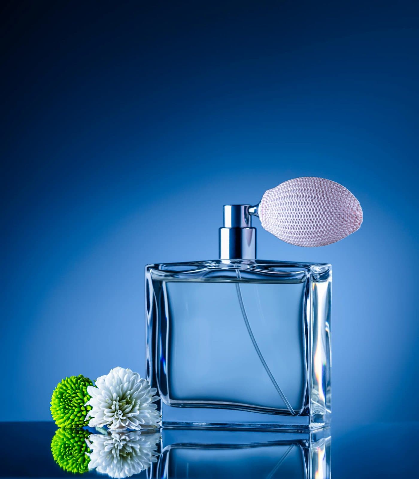 Blue glass perfume bottle with a vintage atomizer bulb