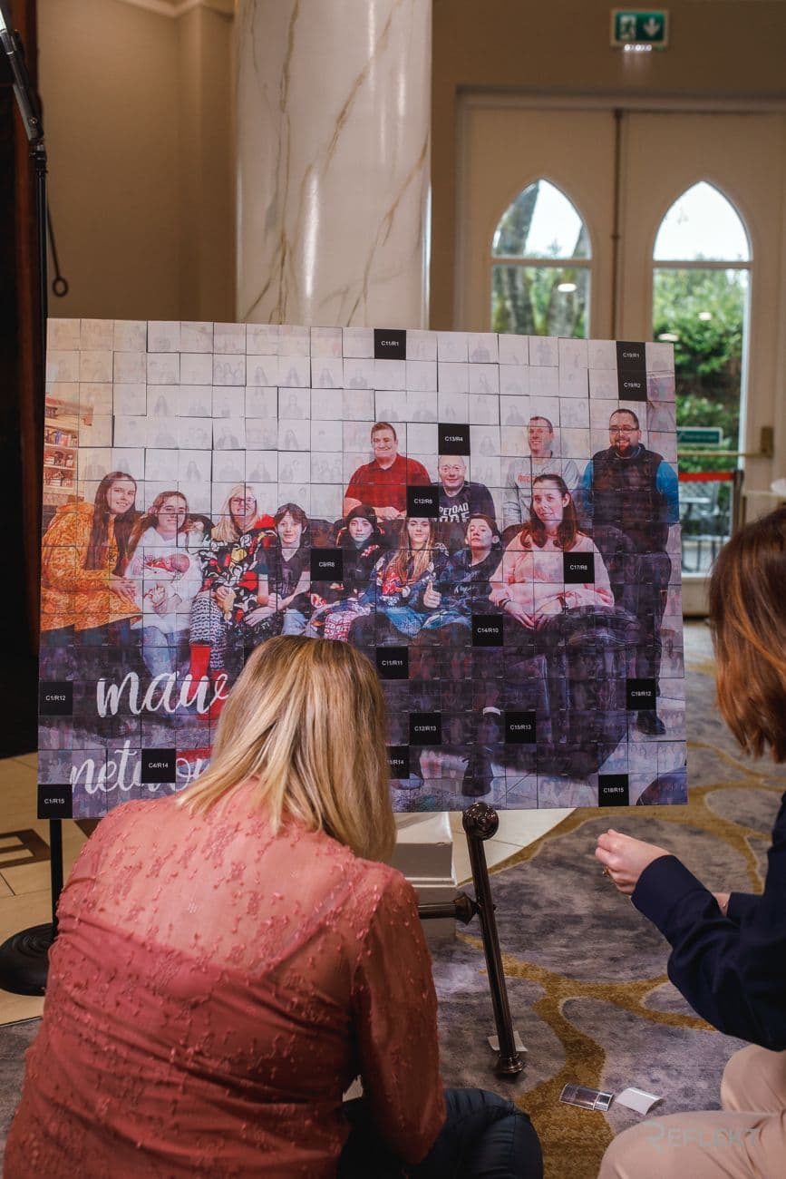 Guests adding photo tiles to a mosaic wall