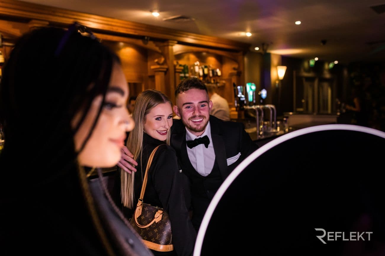 Guests posing for a roaming photo booth in a hotel bar